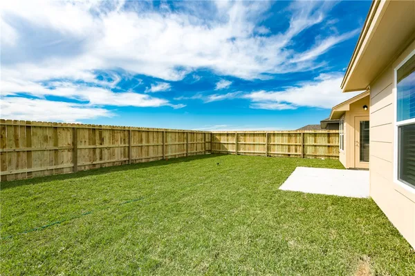 a view of a yard with a house in the background