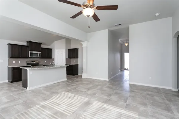 a view of kitchen with sink microwave and refrigerator