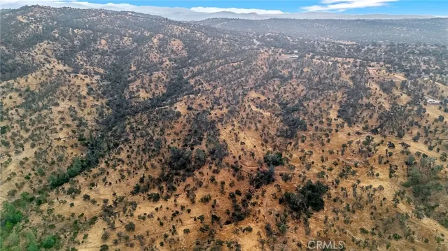 an aerial view of residential houses with city view