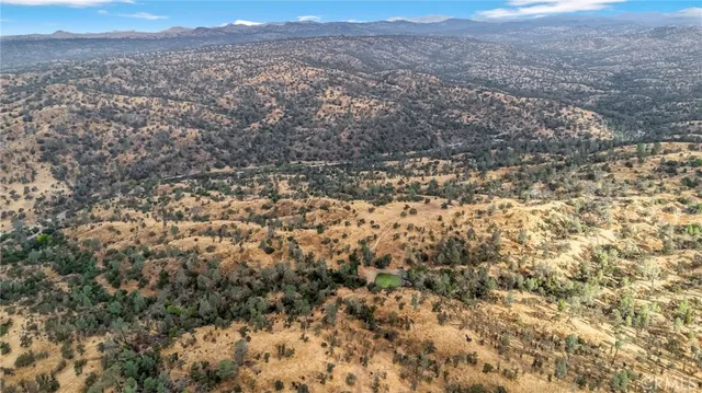 a view of a field with mountains in the background