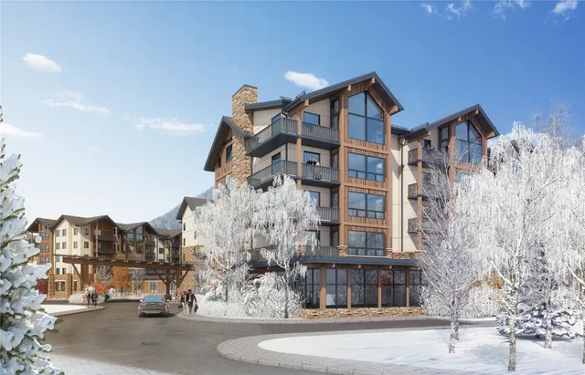 a front view of a residential apartment building with yard and green space