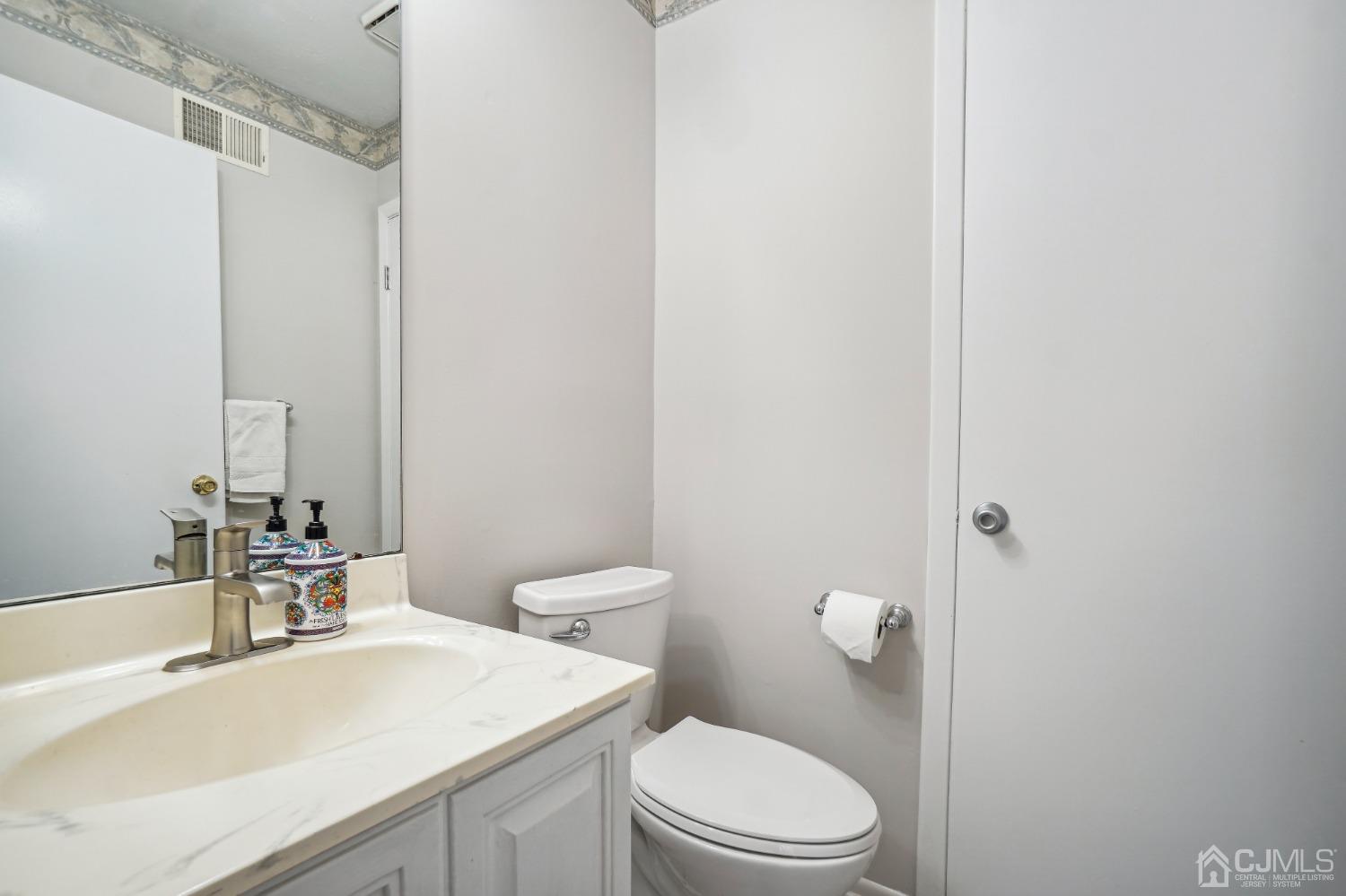 138 Nebula Road Piscataway, NJ 08854 - Photo 11 of 17 a bathroom with a sink a toilet a mirror and shower