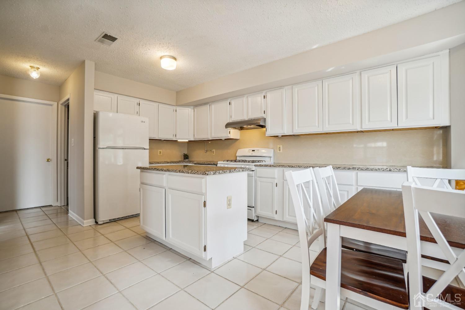138 Nebula Road Piscataway, NJ 08854 - Photo 4 of 17 a kitchen with a cabinets and white appliances