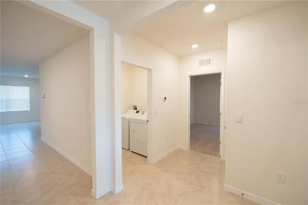 an empty room with wooden floor and bathroom