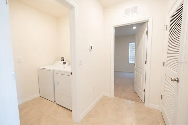 a view of a kitchen with white cabinets