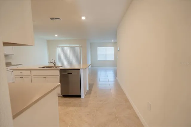 a kitchen with stainless steel appliances a sink stove and refrigerator