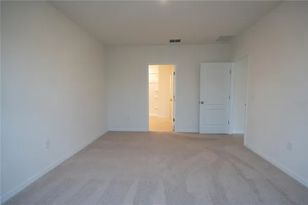 a spacious bathroom with a double vanity sink a mirror and a shower
