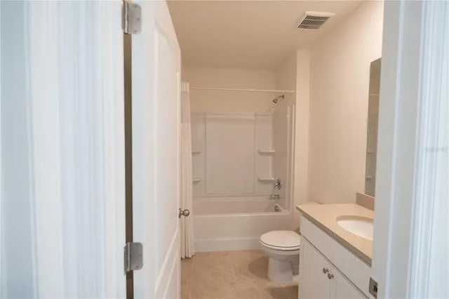 a bathroom with a granite countertop toilet a sink and shower