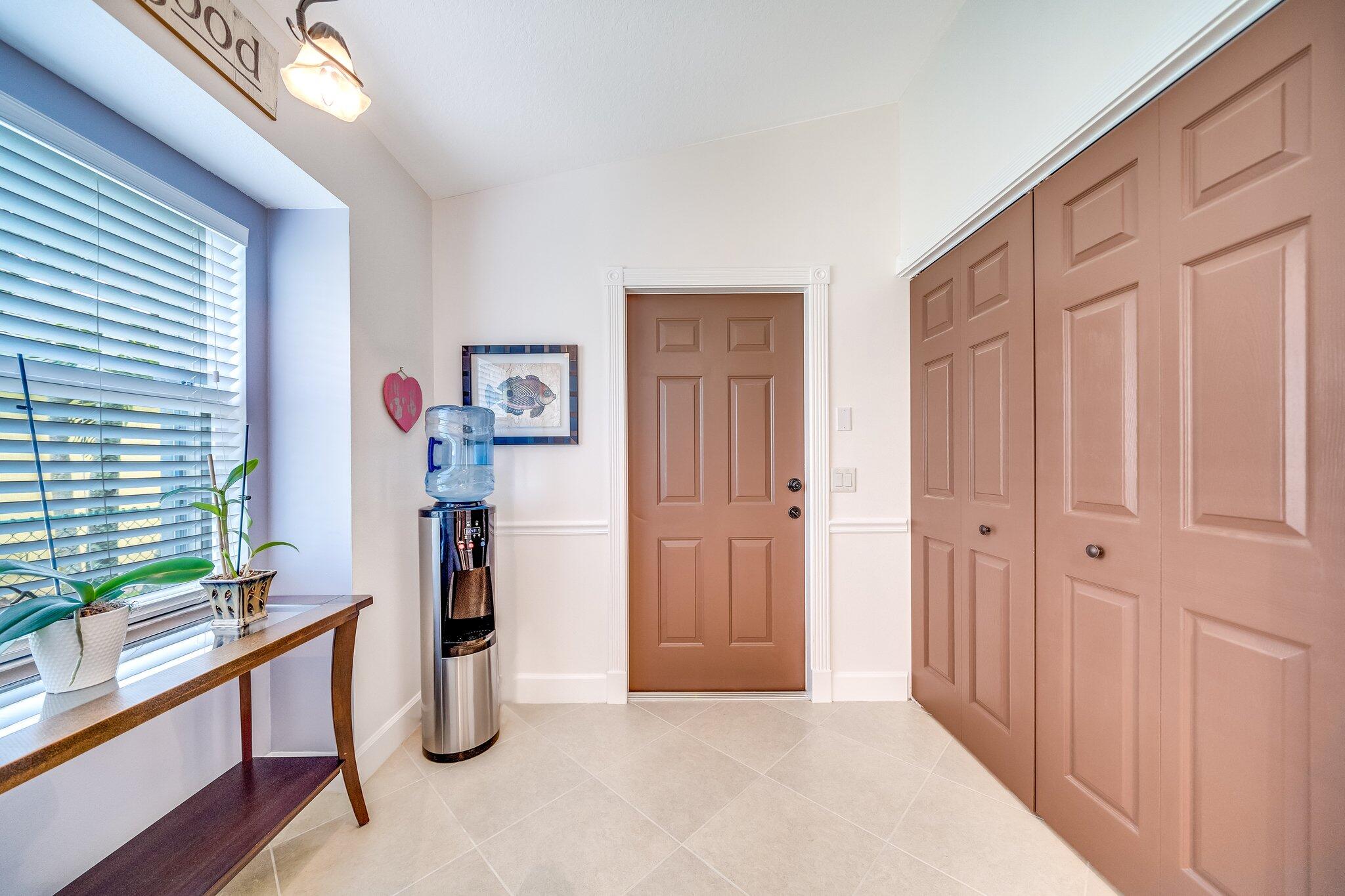 2511 Southwest Regency Road Stuart, FL 34997 - Photo 25 of 33 Garage Entry Door / Laundry Closet