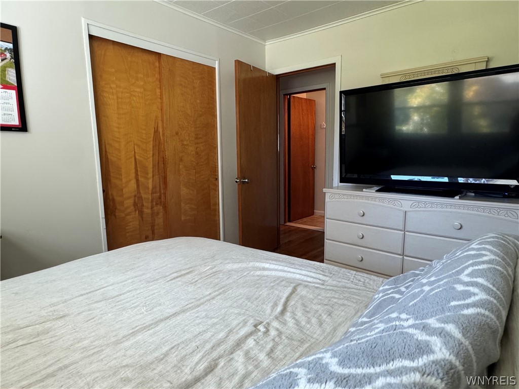 10180 Partridge Road Colden, NY 14080 - Photo 20 of 34 Warm wood doors and classic molding define this comfortable, inviting bedroom layout.