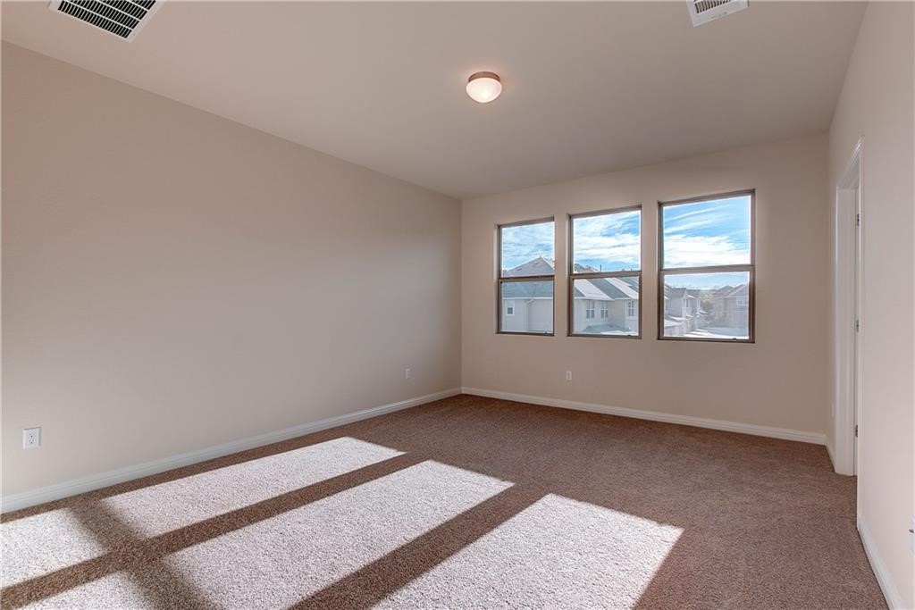 6907 Idea Road Austin, TX 78741 - Photo 21 of 29 2nd level primary bedroom with carpet with lots of natural light