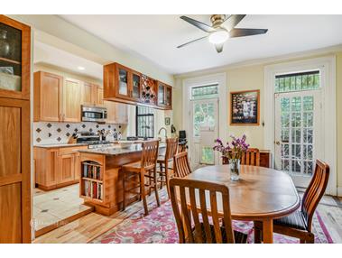 a view of kitchen with cabinets table and chairs