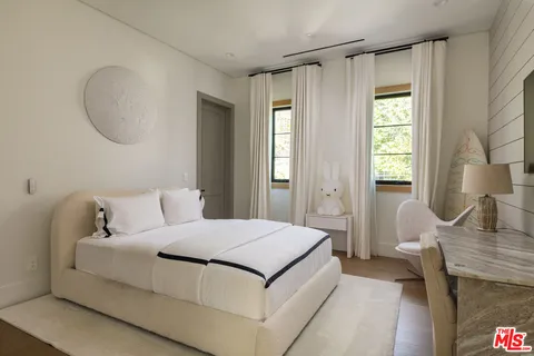 a living room with a bed furniture and a window