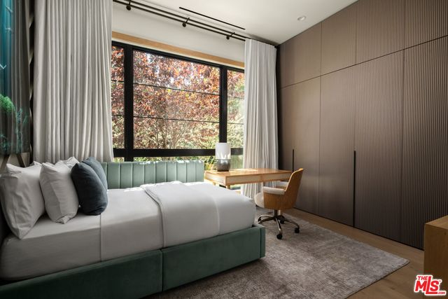 a bedroom with a bed and a window