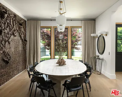 a dining room with furniture window and outside view