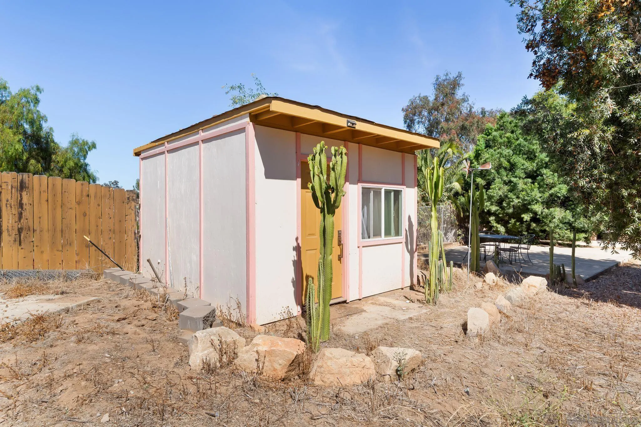 8968 Rocket Ridge Road Lakeside, CA 92040 - Photo 16 of 16 a view of a house with wooden fence next to a yard