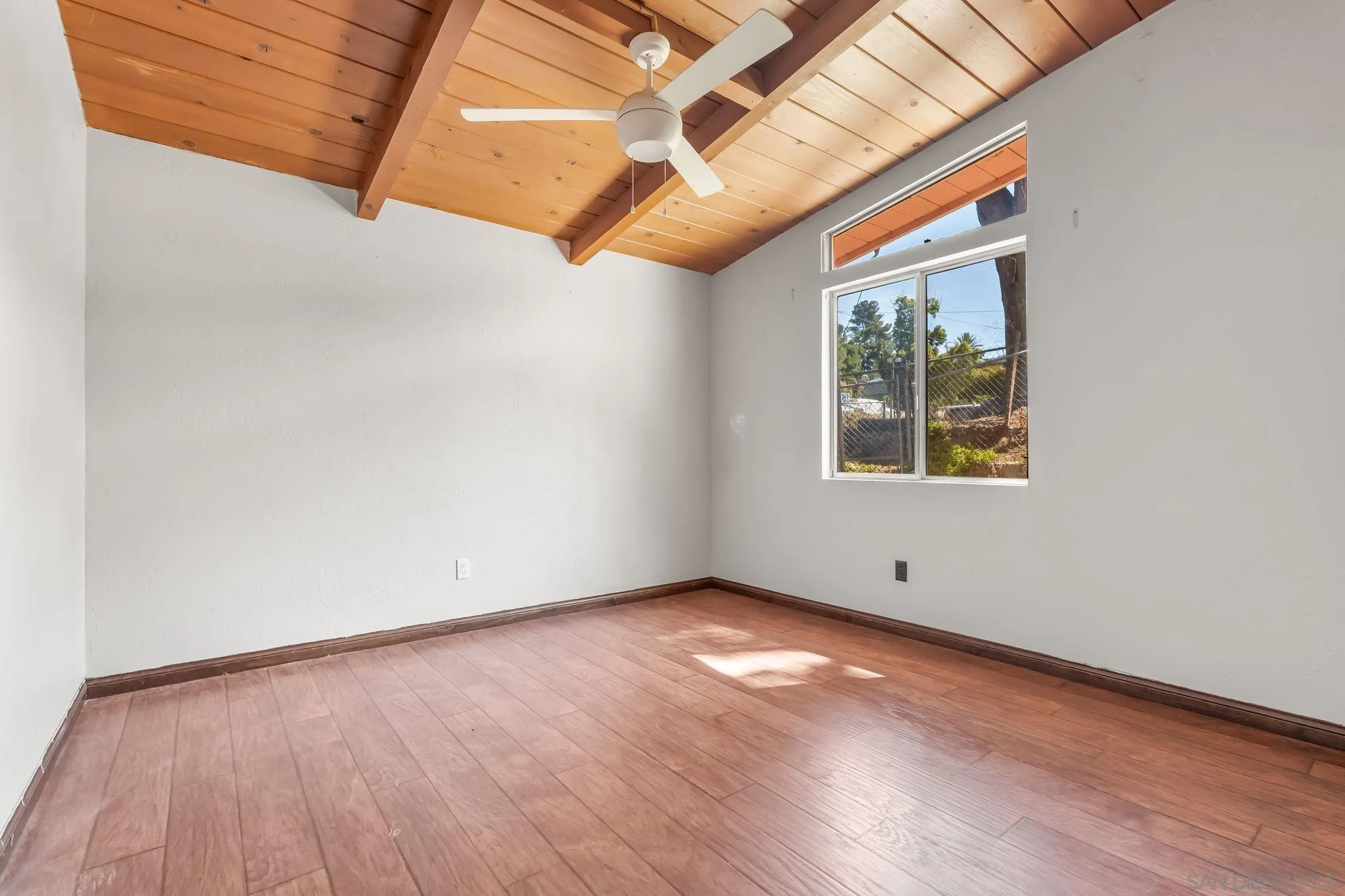 8968 Rocket Ridge Road Lakeside, CA 92040 - Photo 9 of 16 an empty room with wooden floor and windows