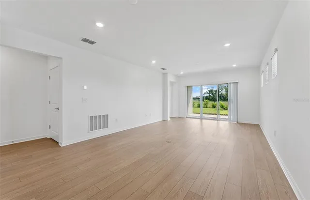 a view of an empty room and wooden floor