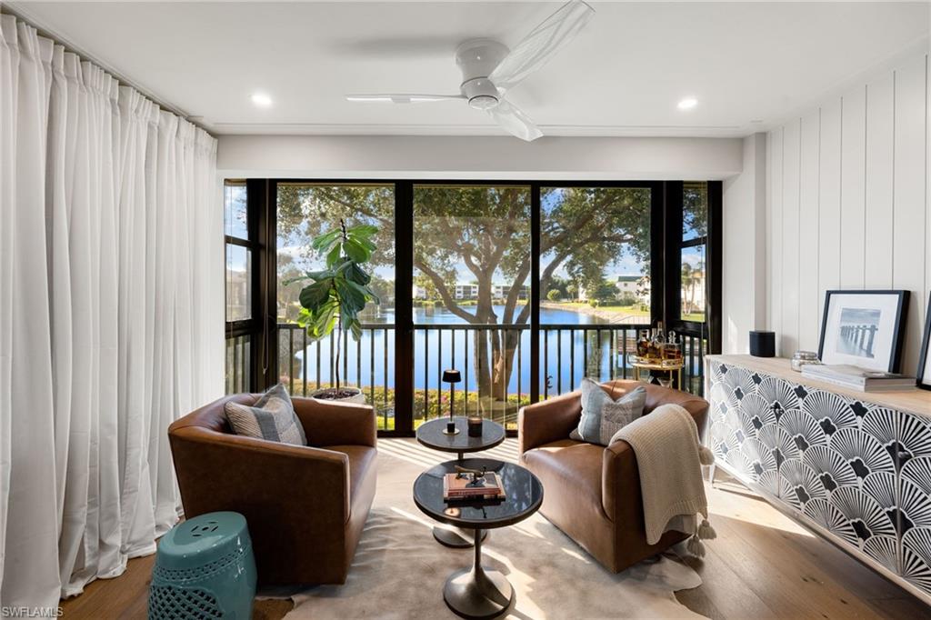 3135 Riviera Drive, Unit B205 Naples, FL 34103 - Photo 11 of 48 a bedroom with furniture and a large window