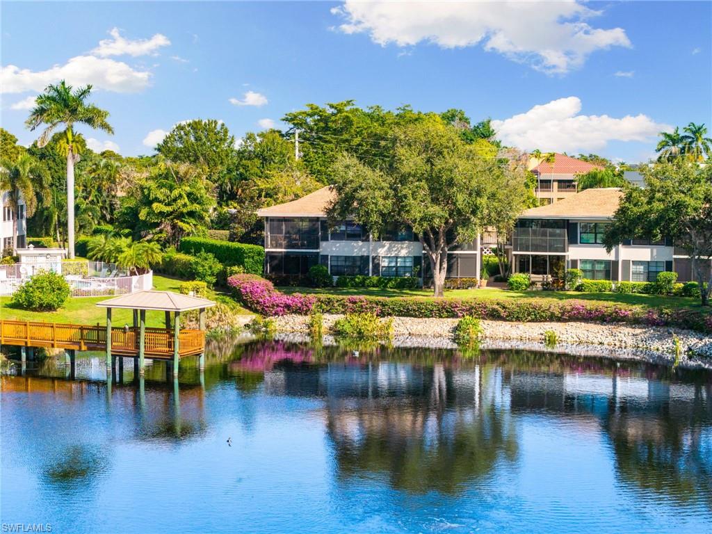 3135 Riviera Drive, Unit B205 Naples, FL 34103 - Photo 13 of 48 a view of a swimming pool with outdoor seating