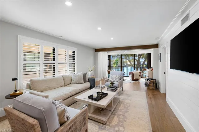 a bedroom with furniture and a large window