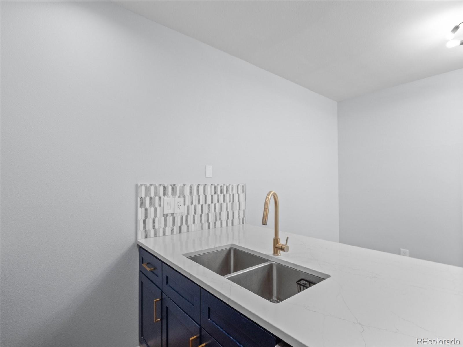 5335 Pecos Way, Unit 4 Denver, CO 80221 - Photo 11 of 25 a kitchen with a sink and cabinets