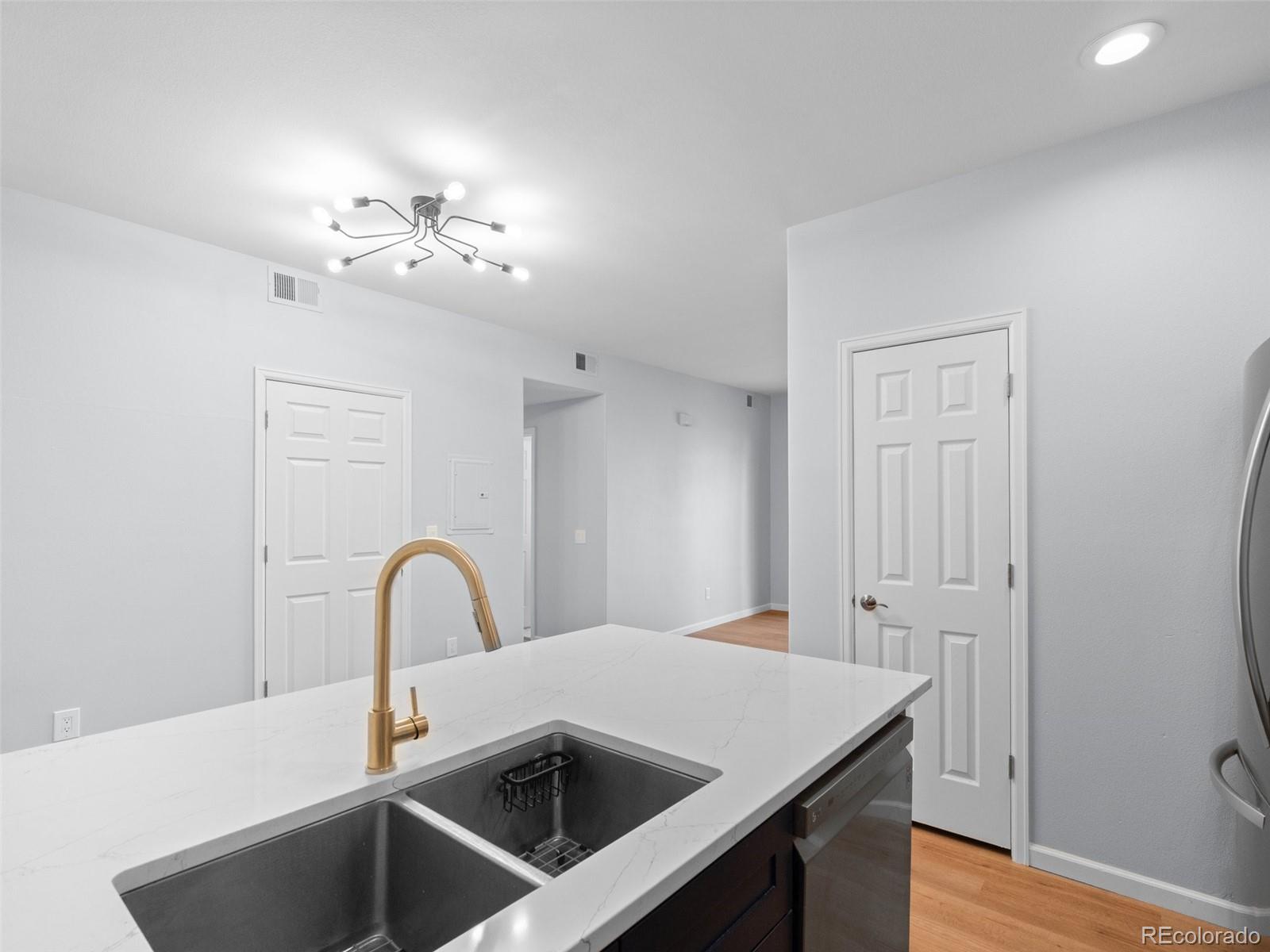 5335 Pecos Way, Unit 4 Denver, CO 80221 - Photo 12 of 25 a view of a sink and chandelier