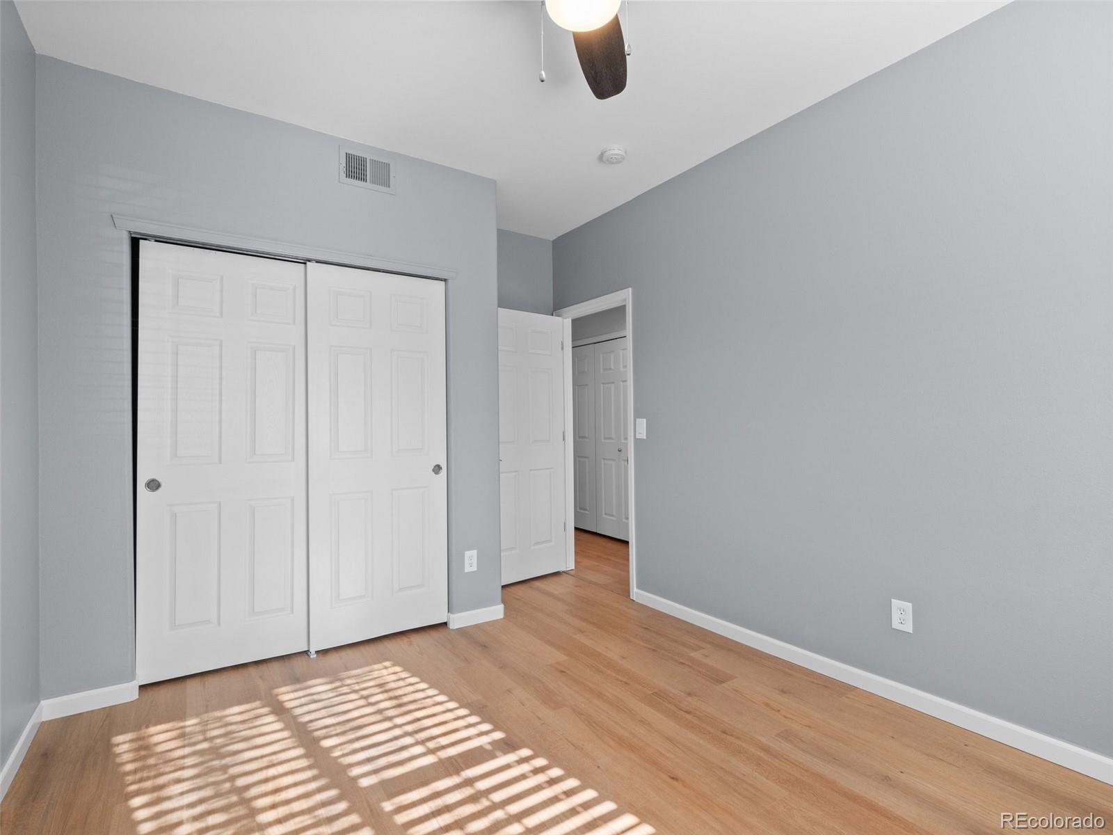 5335 Pecos Way, Unit 4 Denver, CO 80221 - Photo 20 of 25 a view of an empty room with wooden floor