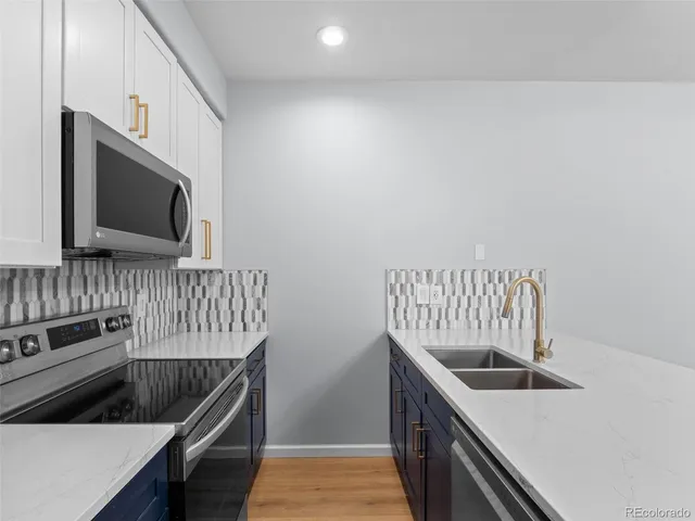 a kitchen that has a microwave and a sink