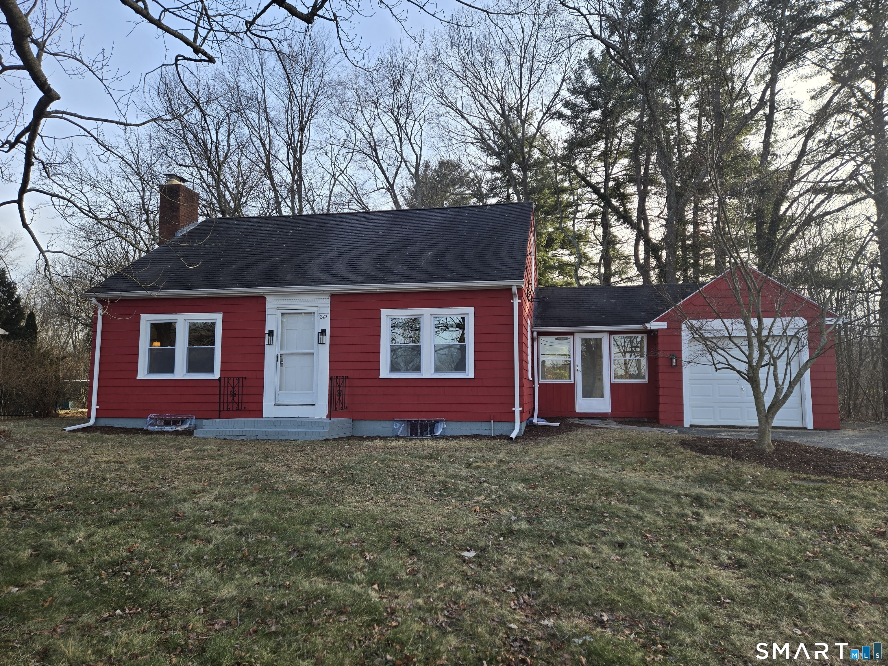 242 Elm Street Enfield, CT 06082 - Photo 1 of 21 a front view of house with yard and trees