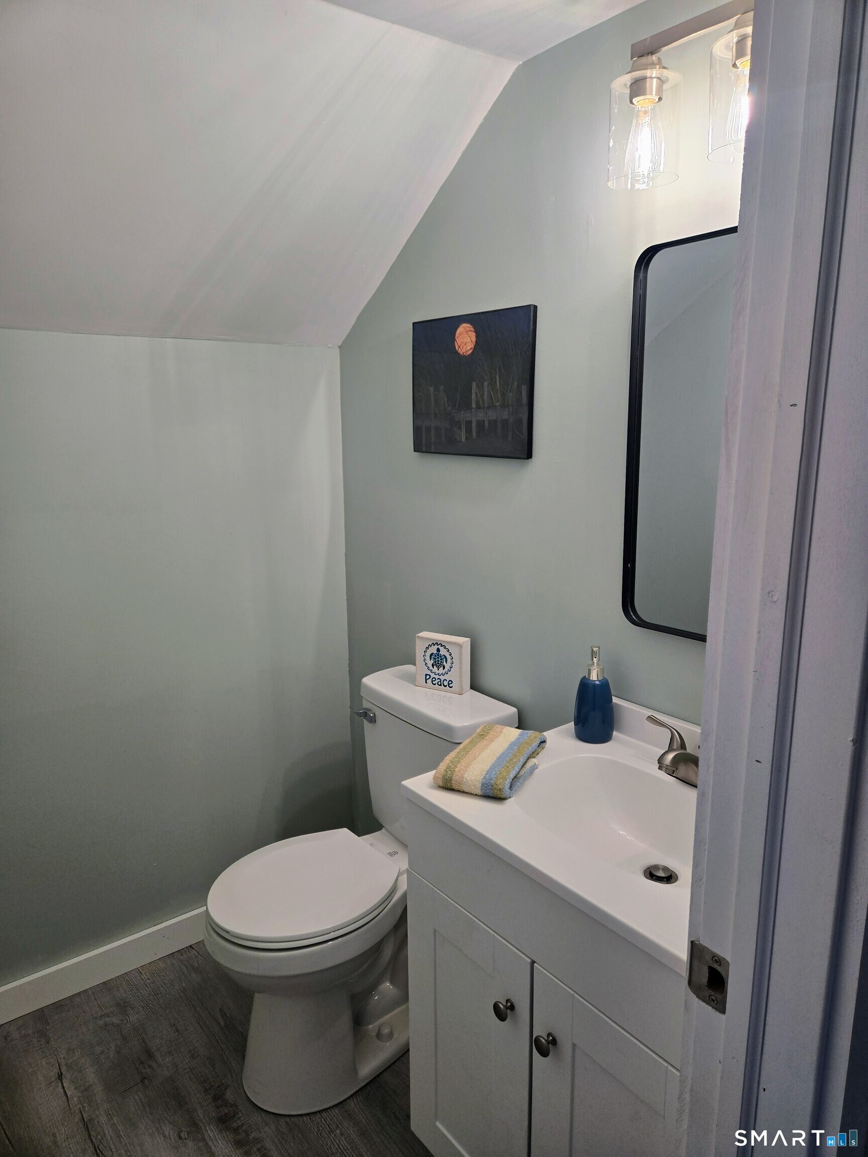 242 Elm Street Enfield, CT 06082 - Photo 16 of 21 a bathroom with a toilet sink and mirror