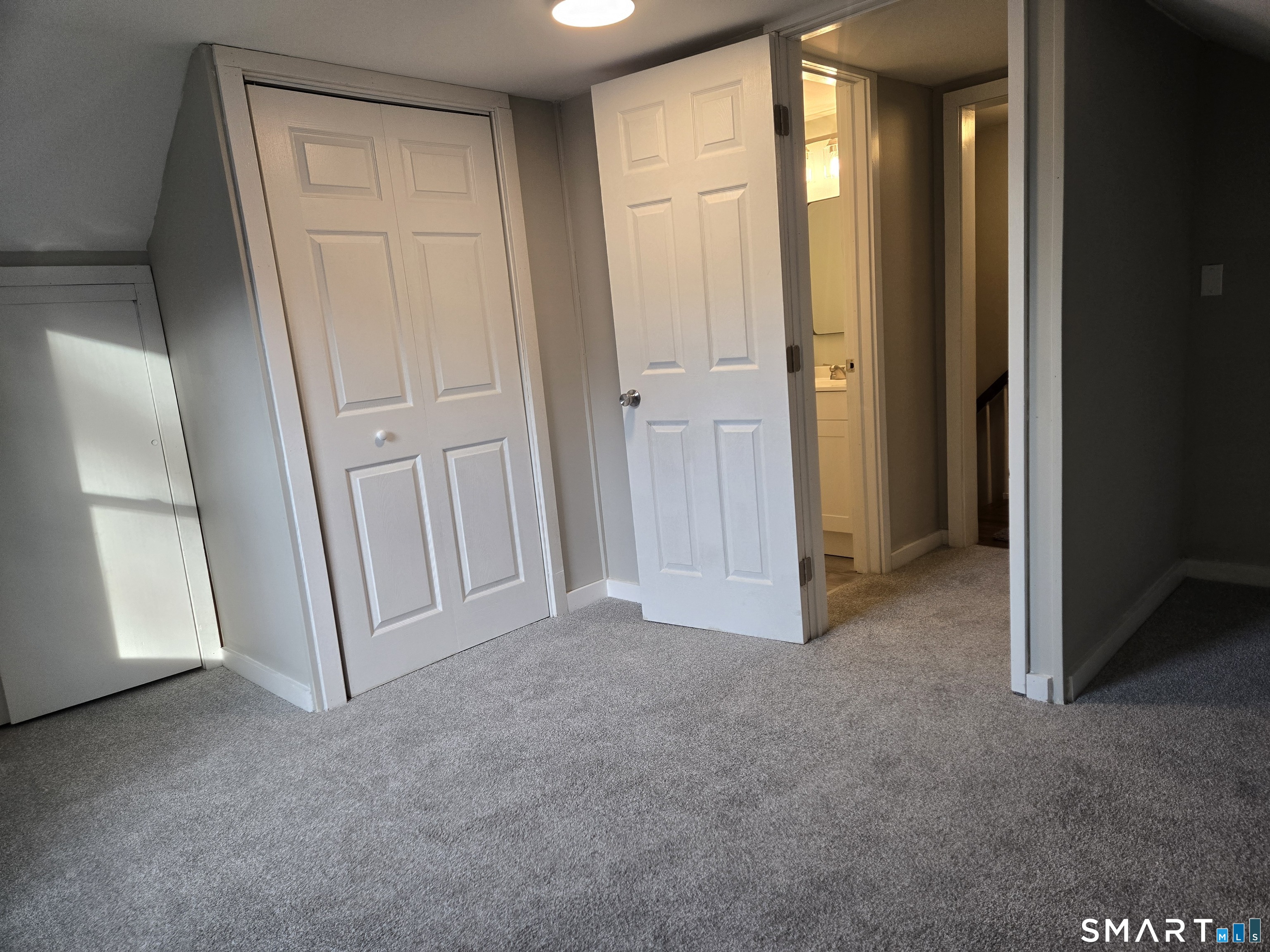 242 Elm Street Enfield, CT 06082 - Photo 18 of 21 an empty room with windows and closet