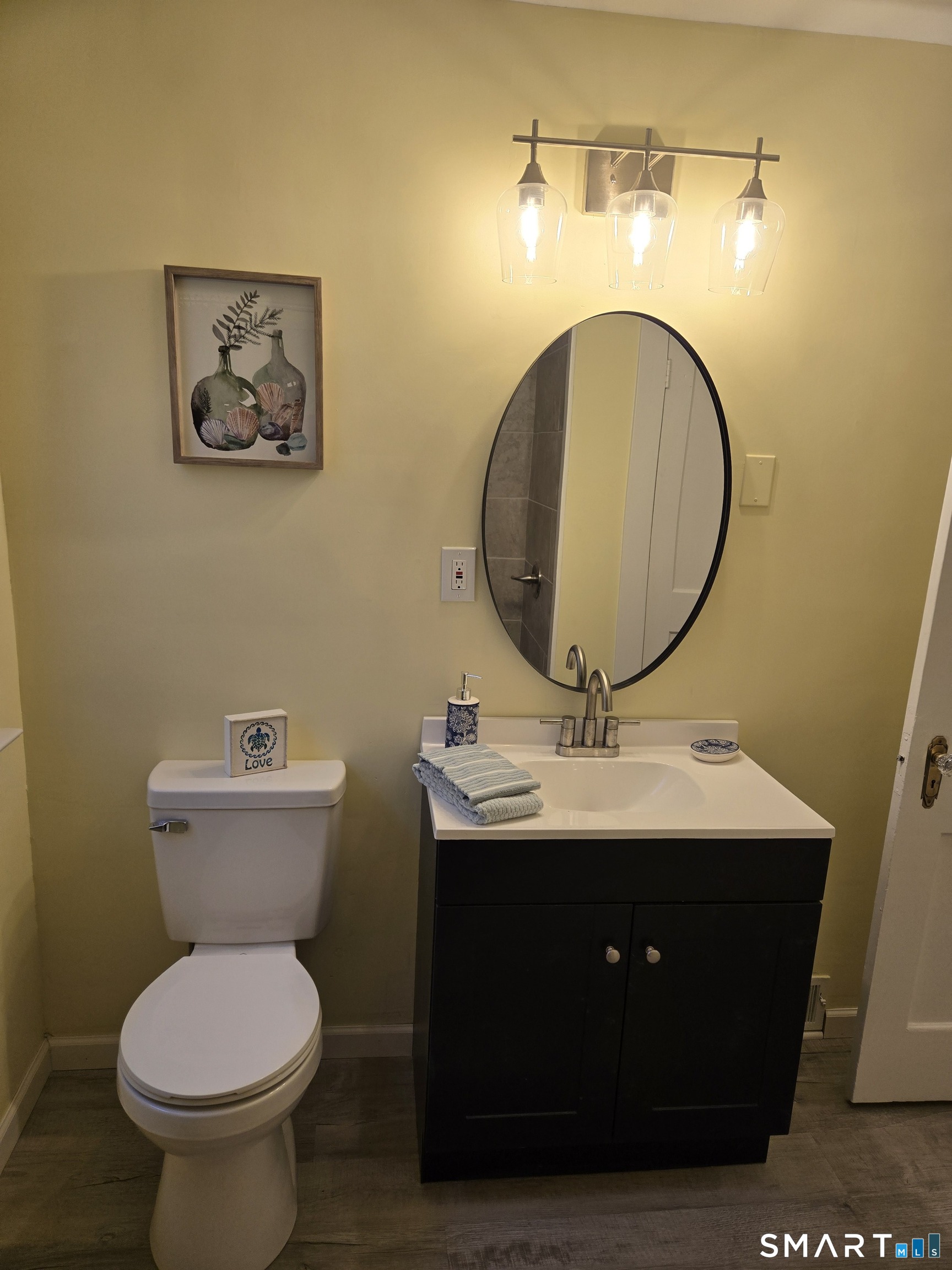 242 Elm Street Enfield, CT 06082 - Photo 19 of 21 a bathroom with a toilet a sink and mirror