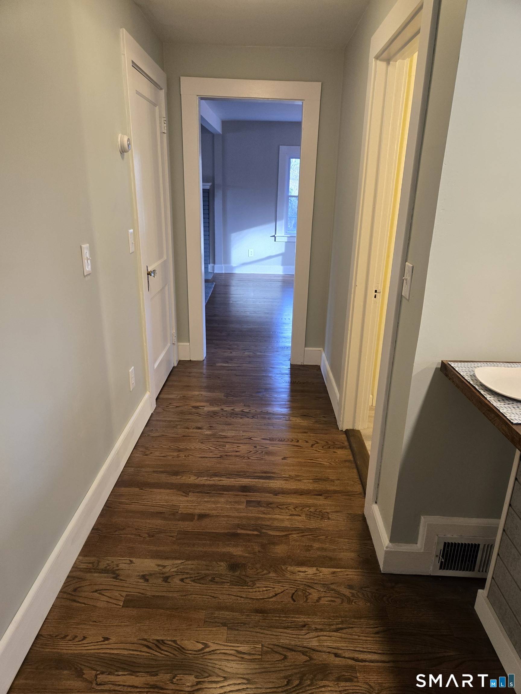 242 Elm Street Enfield, CT 06082 - Photo 5 of 21 a view of a hallway with wooden floor