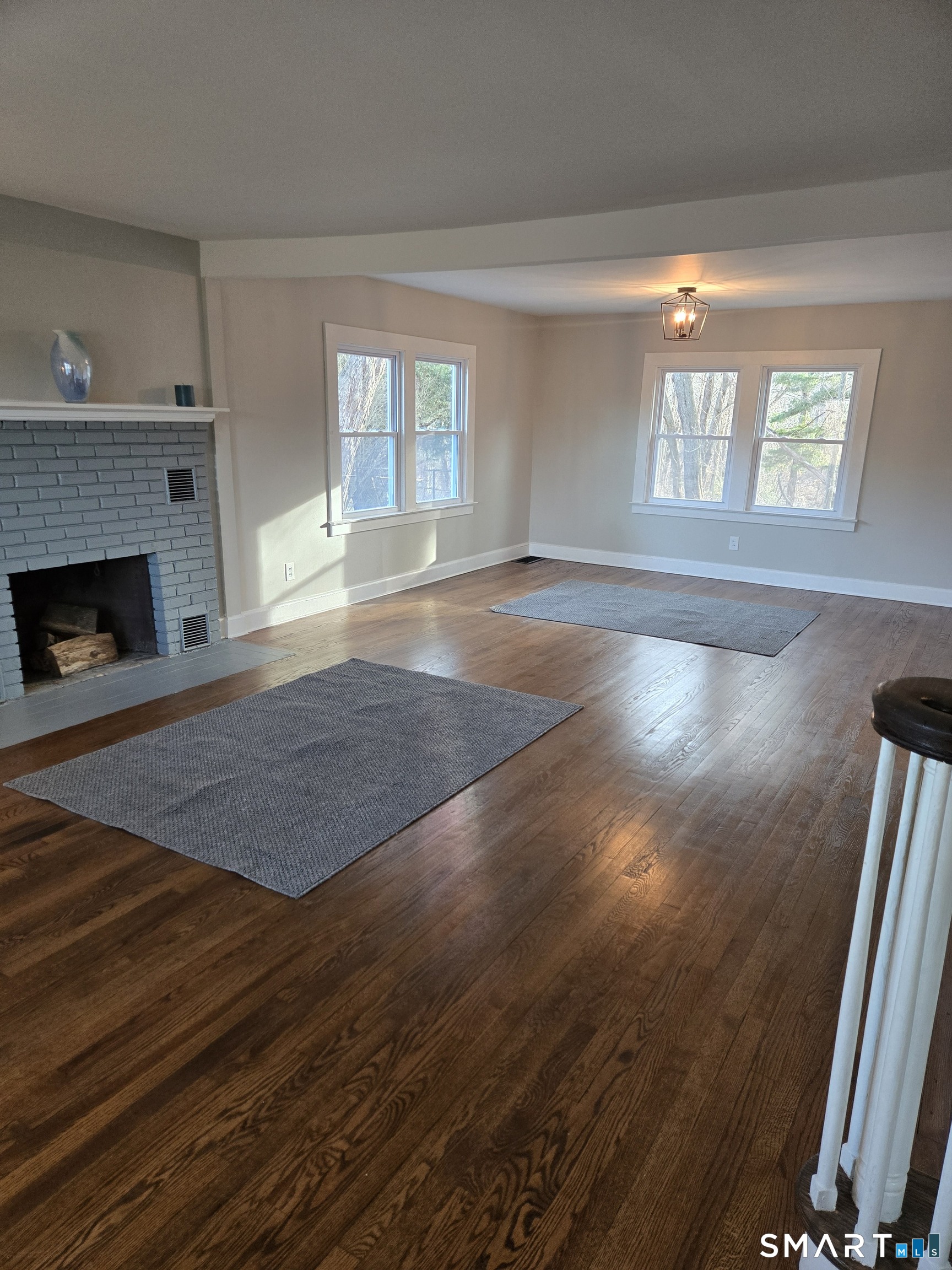 242 Elm Street Enfield, CT 06082 - Photo 9 of 21 a view of empty room with wooden floor and fireplace