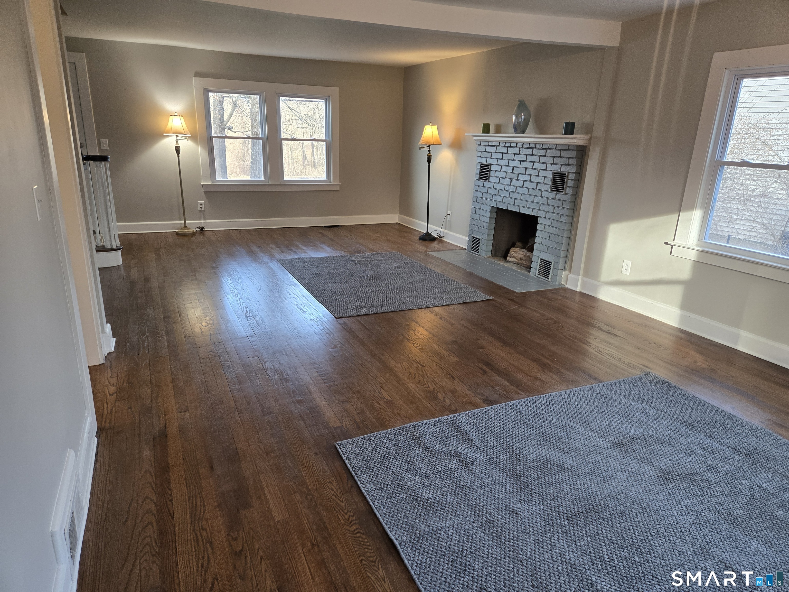 242 Elm Street Enfield, CT 06082 - Photo 10 of 21 wooden floor fireplace and windows in an empty room