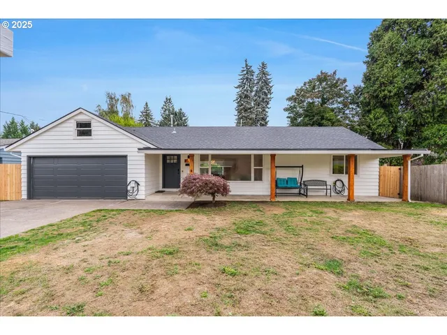 a front view of a house with a garden