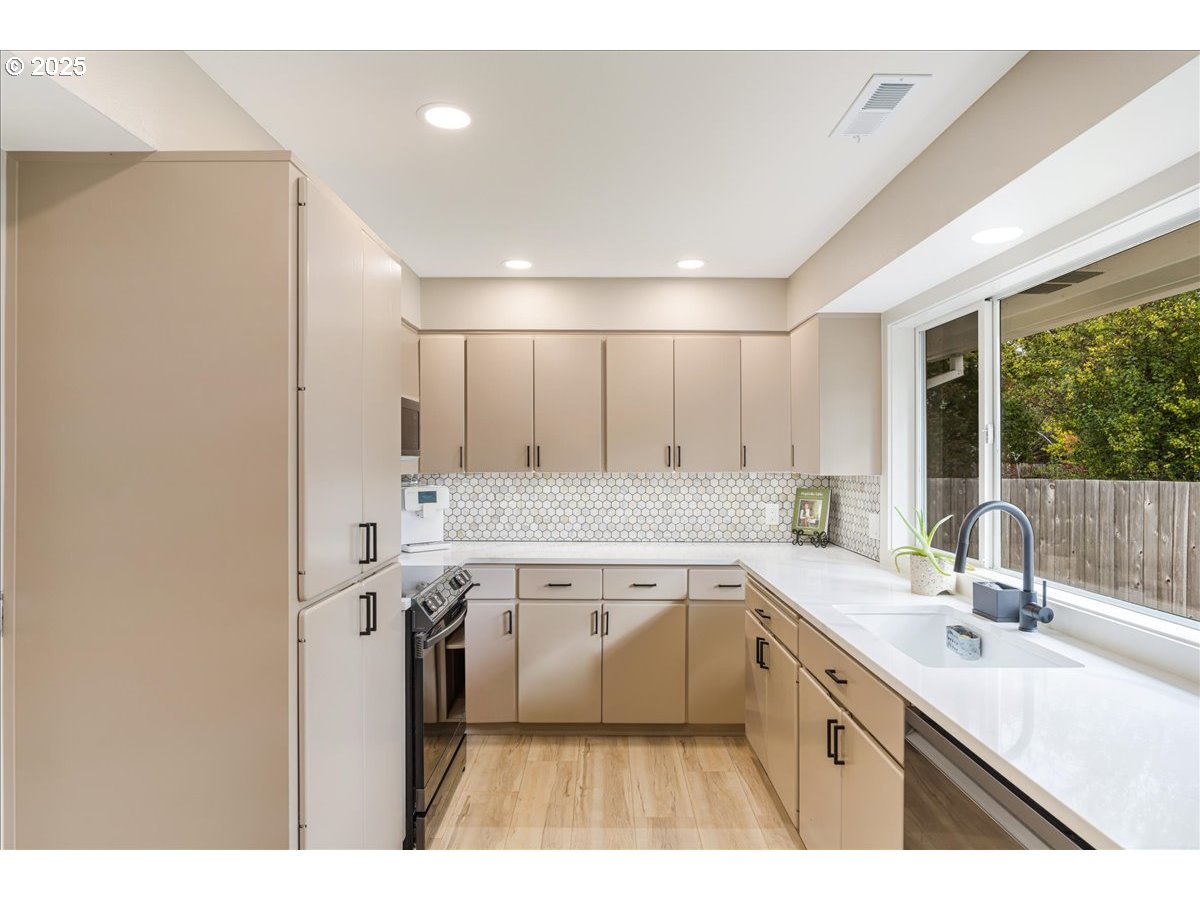 1317 Filbert Street Forest Grove, OR 97116 - Photo 14 of 29 a large kitchen with a sink and cabinets