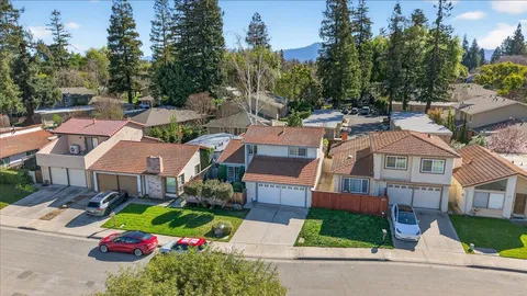 a front view of multiple houses with yard