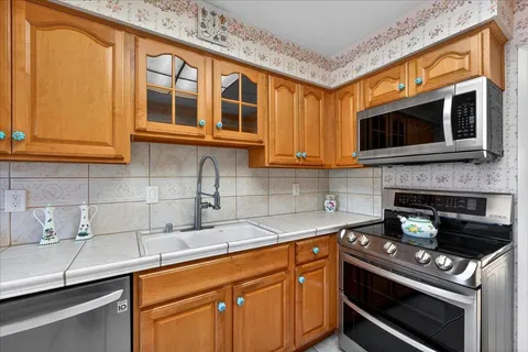 a kitchen with stainless steel appliances granite countertop a sink and cabinets
