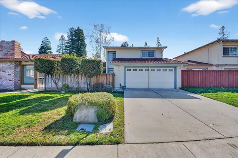 a front view of a house with a yard and a garage
