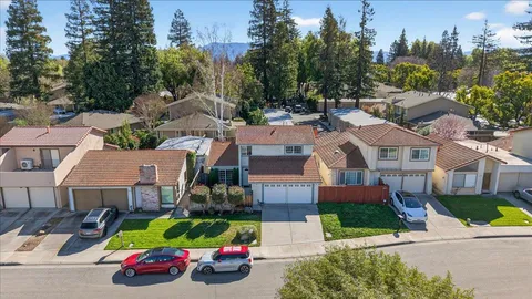 an aerial view of residential houses with yard