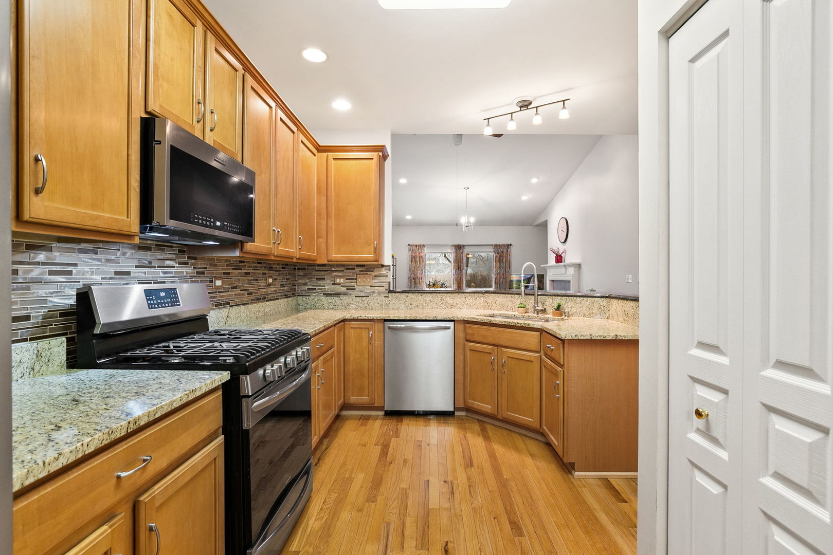 2854 Waterfront Avenue Algonquin, IL 60102 - Photo 6 of 29 a kitchen with granite countertop a sink a counter top space stainless steel appliances and cabinets