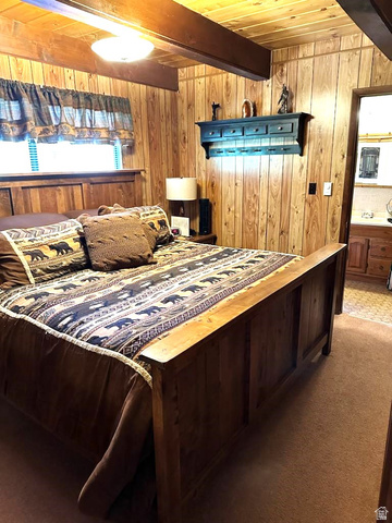 1456 Navajo Road Coalville, UT 84017 - Photo 15 of 55 Carpeted bedroom with wood walls and a wood ceiling with exposed beams