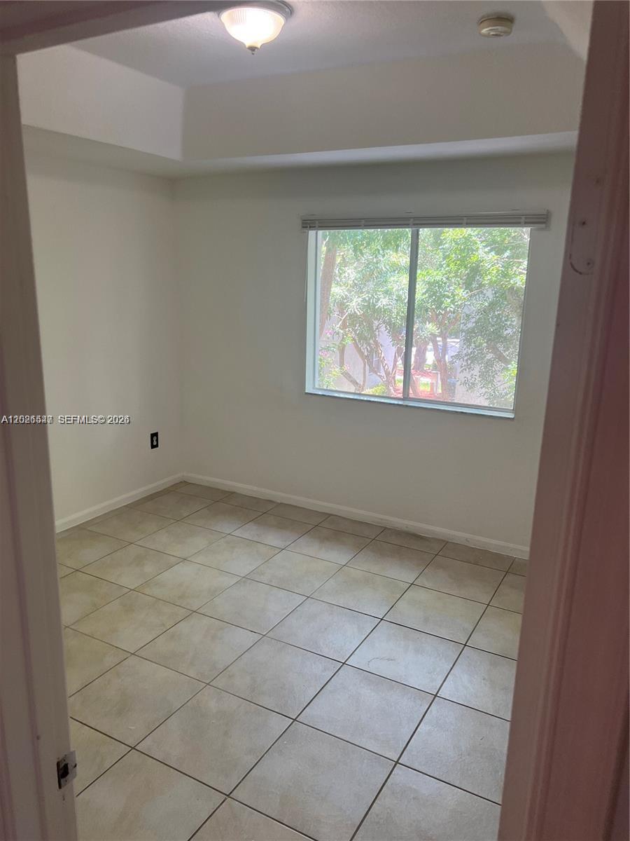 2910 Southeast 15th Road, Unit 55 Homestead, FL 33035 - Photo 9 of 13 an empty room with a window