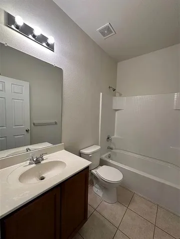 a bathroom with a sink a toilet a mirror and shower