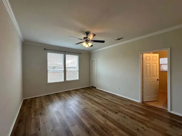 wooden floor in an empty room with a window