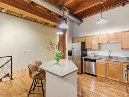 a kitchen with granite countertop sink cabinets and stainless steel appliances