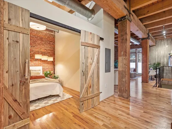 a view of a livingroom with wooden floor and windows