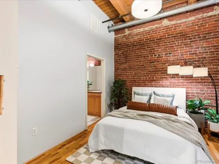 a bedroom with a bed and a wall painting
